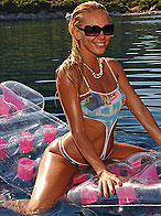 Horny Sandy masturbating on a mattress on the sea