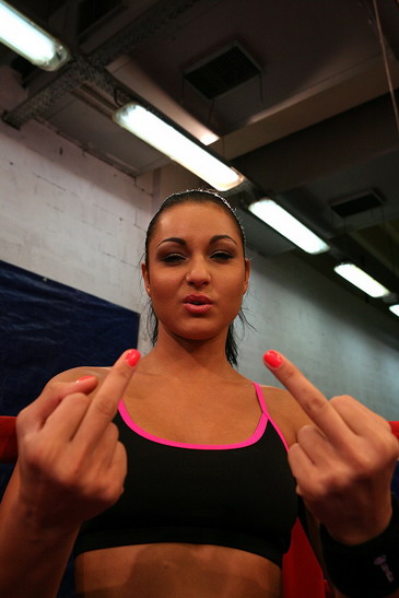 Angry girls are fighting in a boxing ring nudely