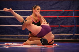 Angry girls are fighting in a boxing ring nudely