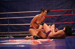 Angry girls are fighting in a boxing ring nudely