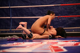 Angry girls are fighting in a boxing ring nudely