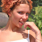 Teenage redhead toying her wet and tight muff in the garden