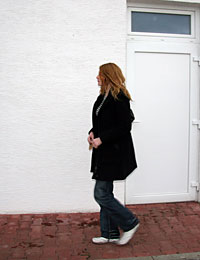 Redhead girl enjoys a big surprise erection trough the wall