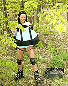 Skating brunette teen girl toying her pussy in the bushes