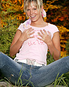 Cute blonde teenager toying her wet pussy in the nature