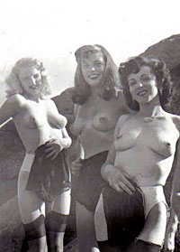 Several sixties beach babes posing naked on a public beach