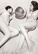 Several sixties beach babes posing naked on a public beach