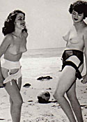Several sixties beach babes posing naked on a public beach