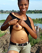 Black teenage girl showing her big natural tits outdoor