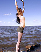 Cute natural teenage brunette goes fully naked on the beach