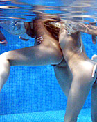 Two teenage girls having fun with their own blowup doll