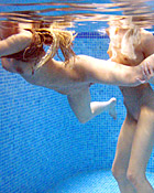 Two teenage girls having fun with their own blowup doll