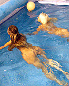 Two teenage girls having fun with their own blowup doll