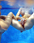 Two teenage girls having fun with their own blowup doll