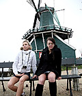 Two Dutch teenagers showing their body in front of windmill