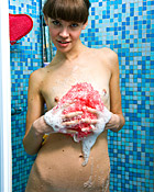 Horny and cute brunette masturbates with her showerhead