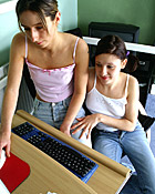 Two lesbians fondling eachother behind the computerscreen