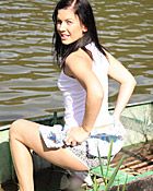 A hot naked chick posing on a boat in the water for camera