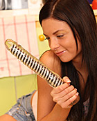 Horny teenager pleasures her wet pussy with glass dildo