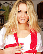 A sexy teenager wearing a nurse outfit undresses completely