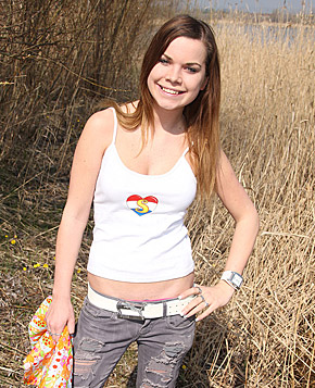 Very horny cutie fondling her pussy outside in the bushes