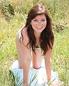 Teenager stroking her moist clit with a big dildo outdoors