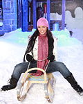 A busty teenage sweetie enjoys playing in the cold snow