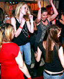 Drunk partygoers having outrageous sex inside of a publicbar