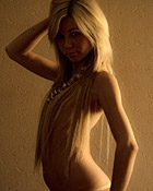 Stunning teenage sweetheart posing naked on a soft carpet