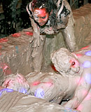 Two very hot teenage girls enjoy getting dirty in a mud tub