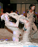 Two very hot teenage girls enjoy getting dirty in a mud tub