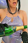 Hot brunette babe pours a bottle of champaigne on herself