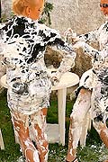  Two sexy babes spraying shaving cream on each other outside