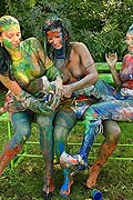 Three hot babes getting messy and naked with paint outside