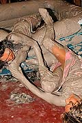 Hot chicks wrestling and pulling off clothes in a mud pit