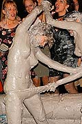 Hot chicks wrestling and pulling off clothes in a mud pit