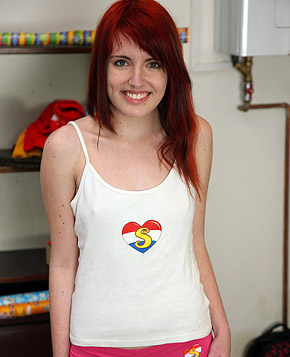 A gorgeous teen redhead enjoys rubbing her moist snatch