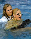 Sexy lesbians love swimming together in a big public pool