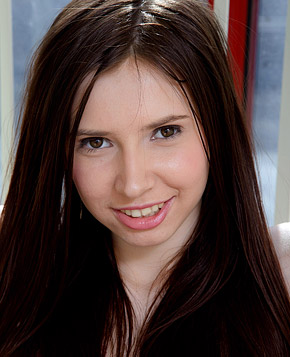  A pretty teenage brunette loves undressing near a window