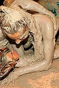 Topless muddy brunette wrestling babe winning the match