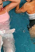 Two hot girls playing in pool wearing see thru clothing