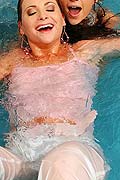 Two hot girls playing in pool wearing see thru clothing
