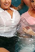 Two hot girls playing in pool wearing see thru clothing