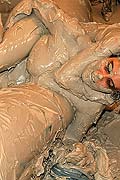 Hot babes tearing off their tops while wrestling in the mud
