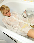 Teenage chick using a shower head to pleasure her snatch