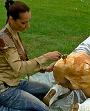 Two cute clothed hotties playing with liquid food outdoors