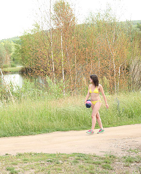 Bikini wearing chick loves playing in a big tree outdoors