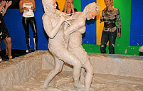 Two hot cuties wrestling together in the dirty grey mud