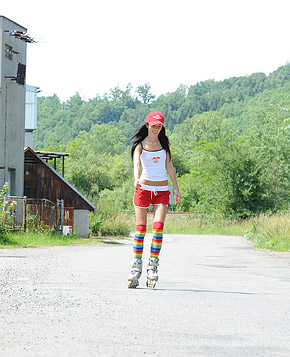 Roller skating babe plays with her soaked cooch outside