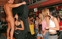 Guy swinging his dick in her face at a massive sex party